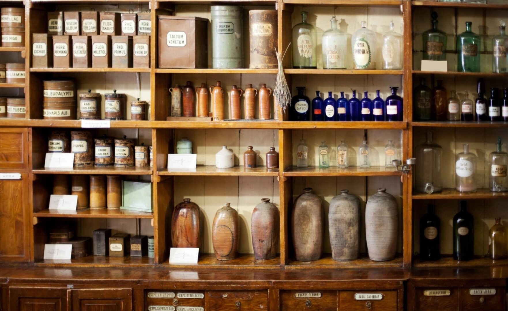 A shelf filled with jars and bottles of medicine.